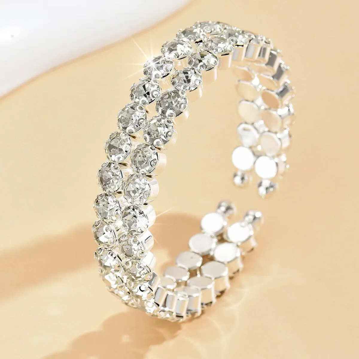 Silver elastic bracelet with double row of large rhinestones and wide opening design