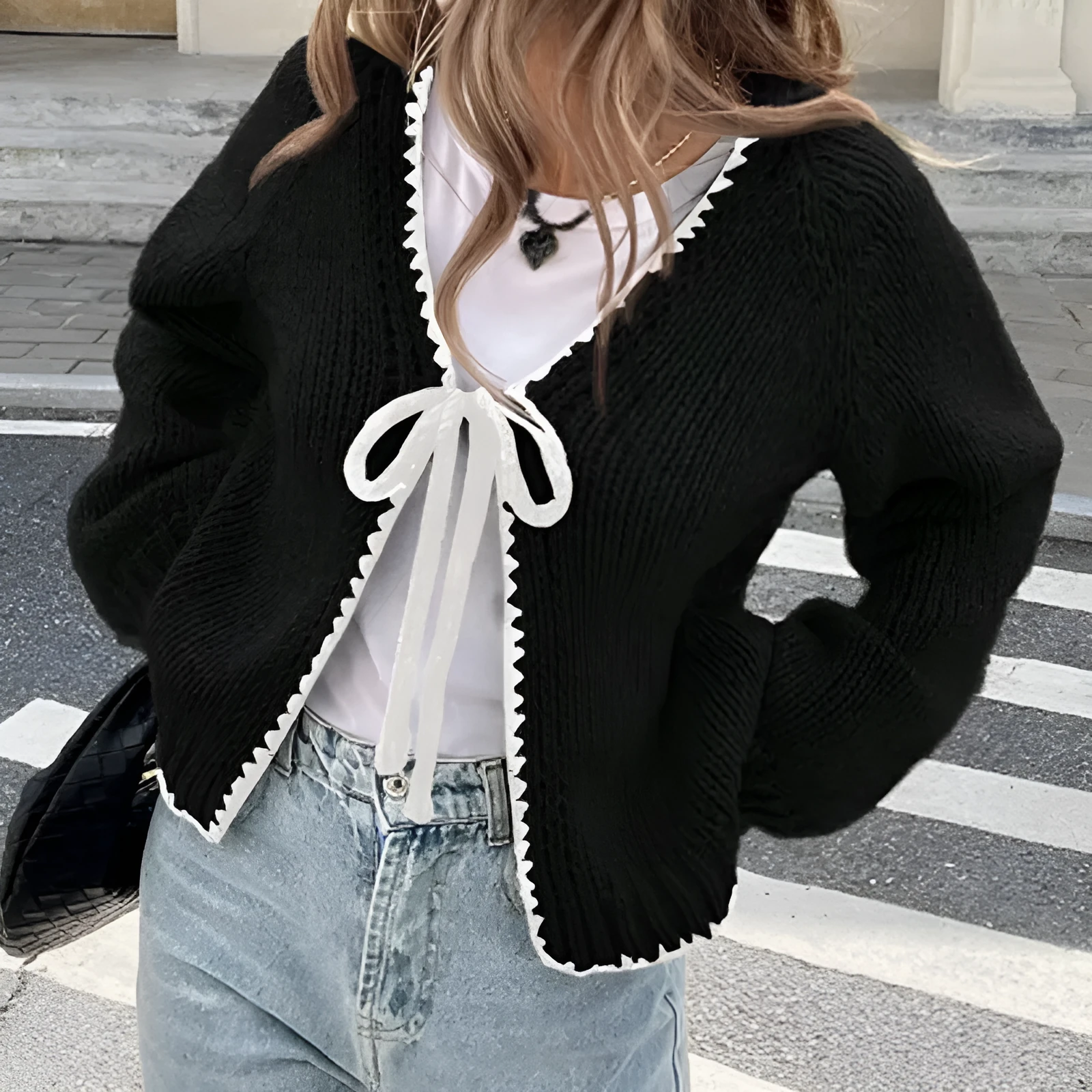 Grey lace-up sweater cardigan with long sleeves and crocheted flower decoration on the front.