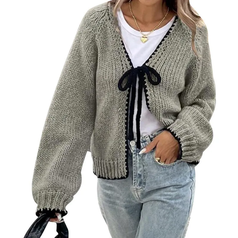Grey lace-up sweater cardigan with long sleeves and crocheted flower decoration on the front.