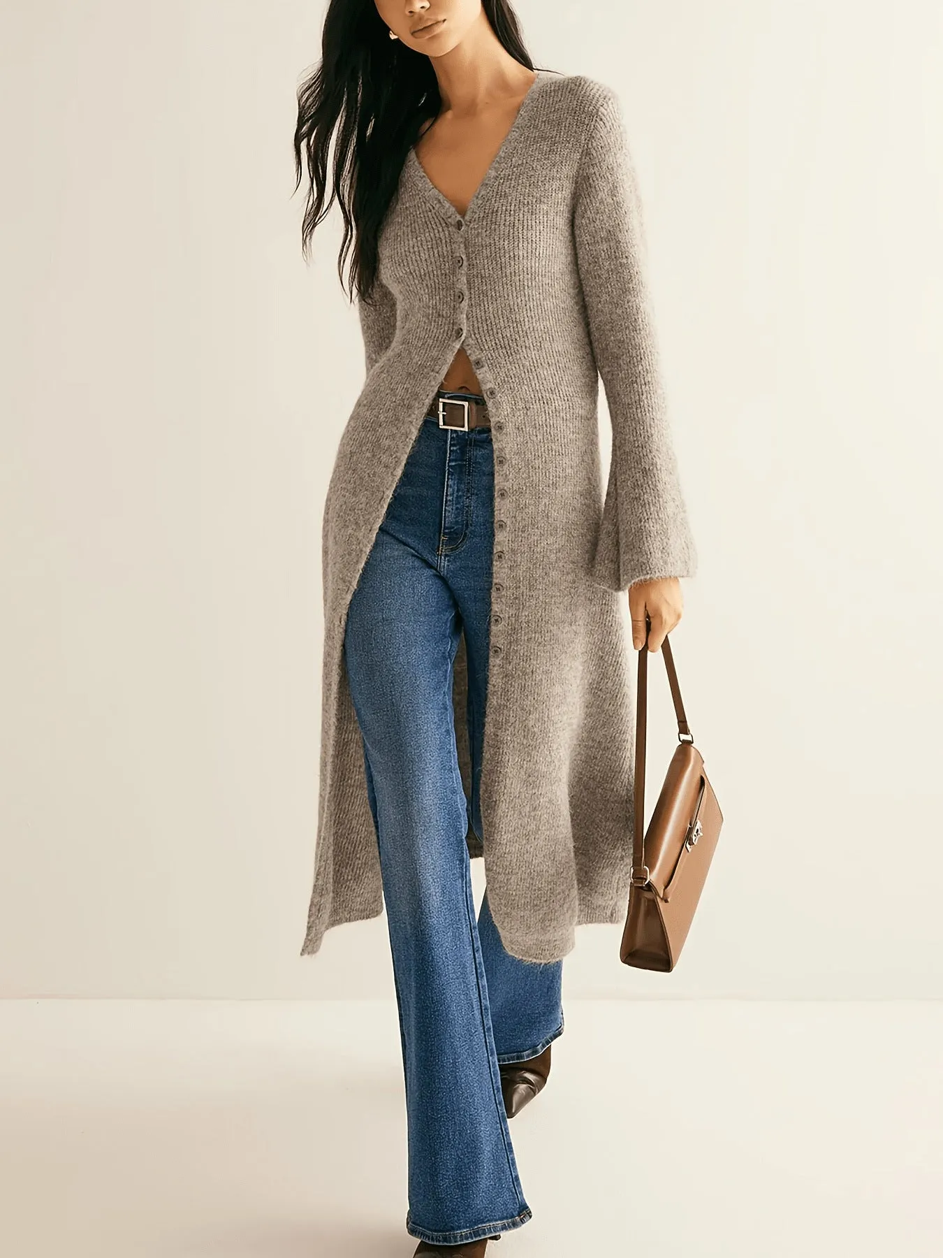 Khaki coloured women's long sleeve button-front cardigan coat on a hanger.
