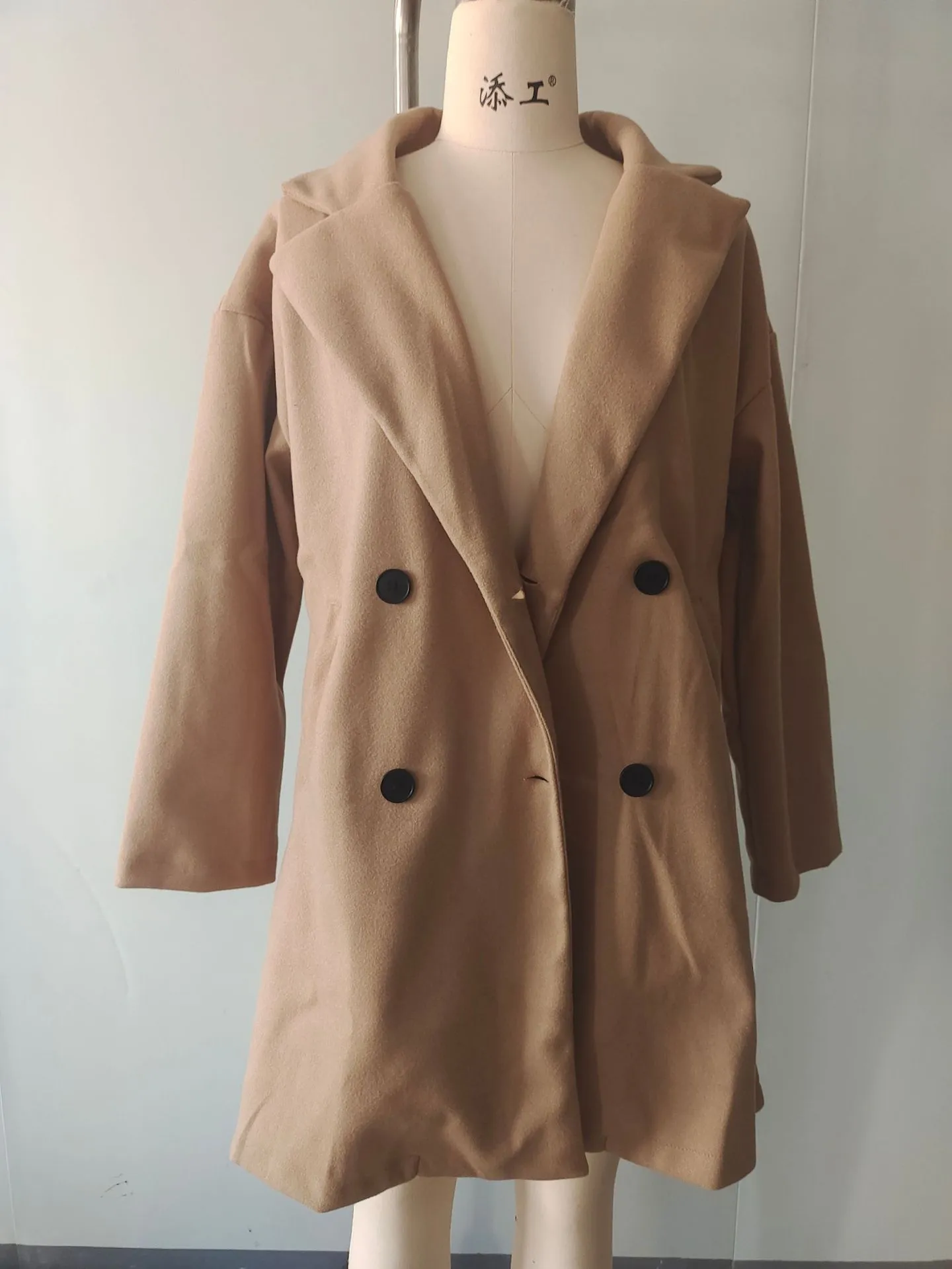 Women's mid-length coat with fur collar, button front, and side pockets in black