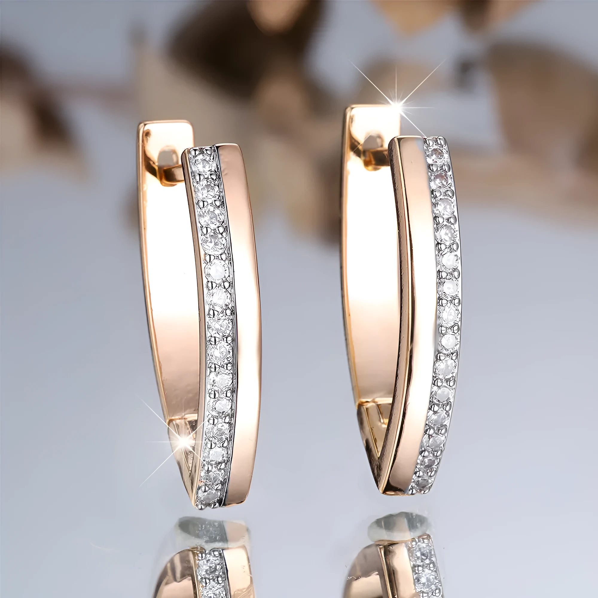 Close-up of women's geometric V-shaped champagne gold ear clips with a clip-on back.