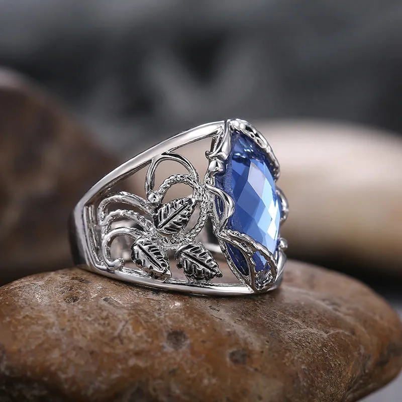 Women's blue crystal horse eye-shaped geometric alloy ring on a white background.