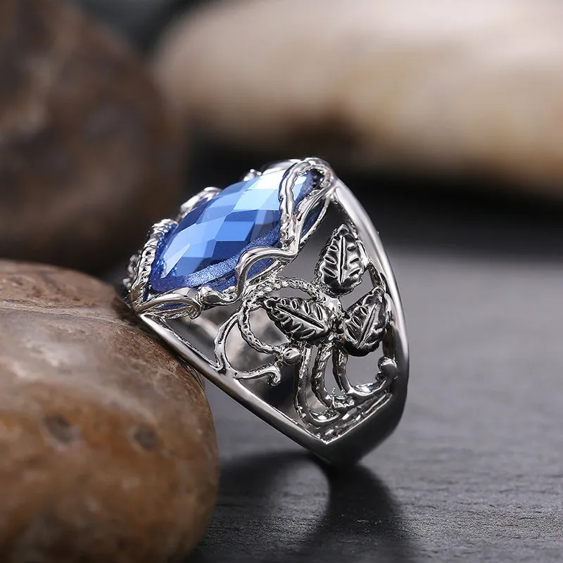 Women's blue crystal horse eye-shaped geometric alloy ring on a white background.