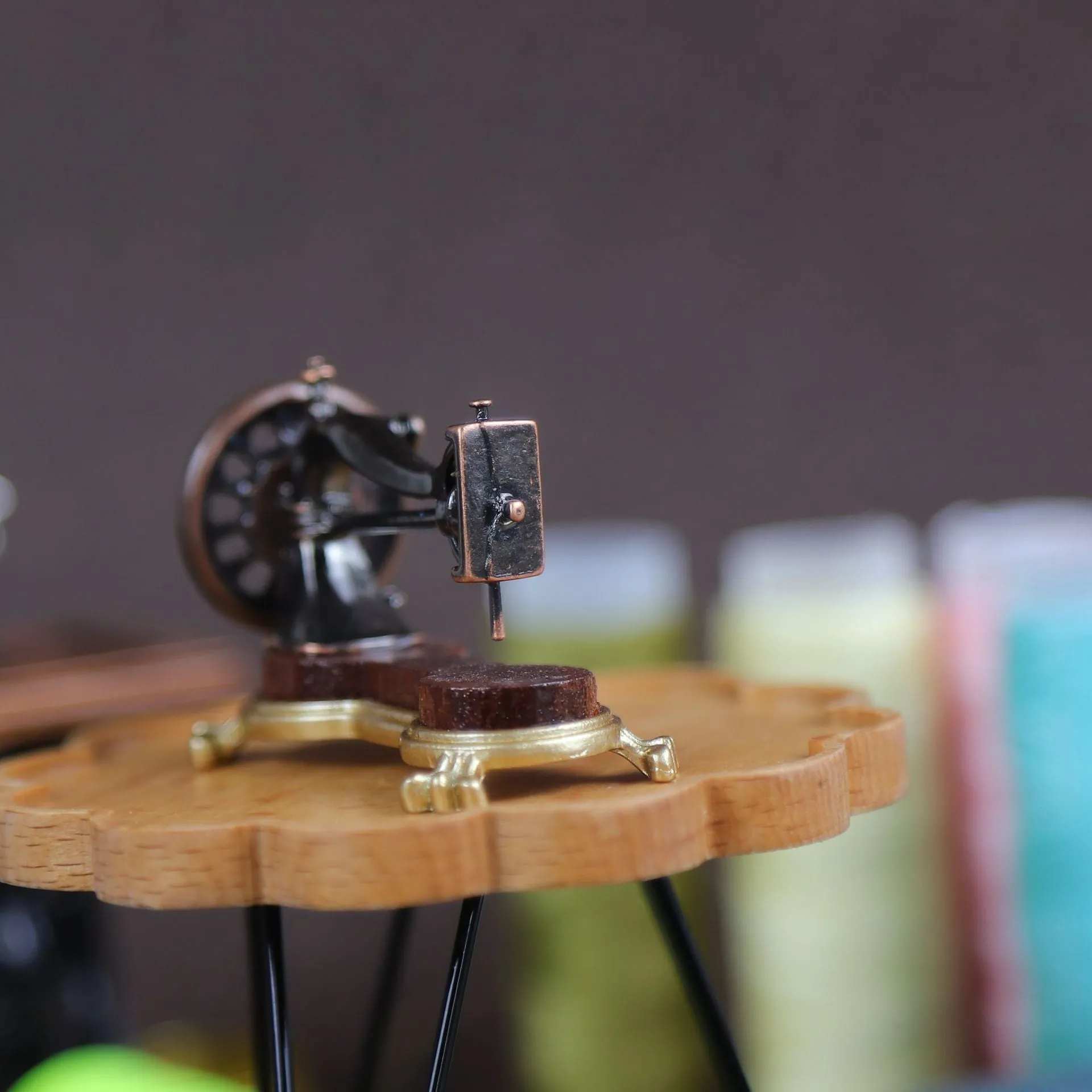Brown metal simulation mini hand sewing machine dollhouse accessory on display