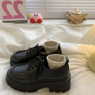 Women's soft leather platform block heel pumps in matte black with round toe and buckle closure