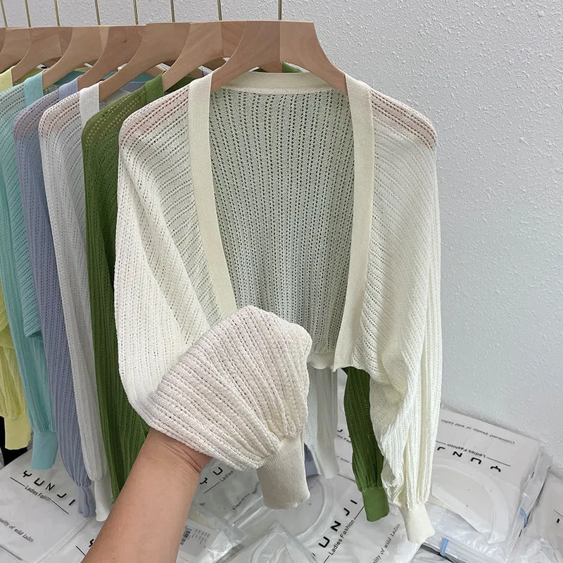 Thin polyester linen blouse with hollow out pattern and long lantern sleeves in apricot colour.