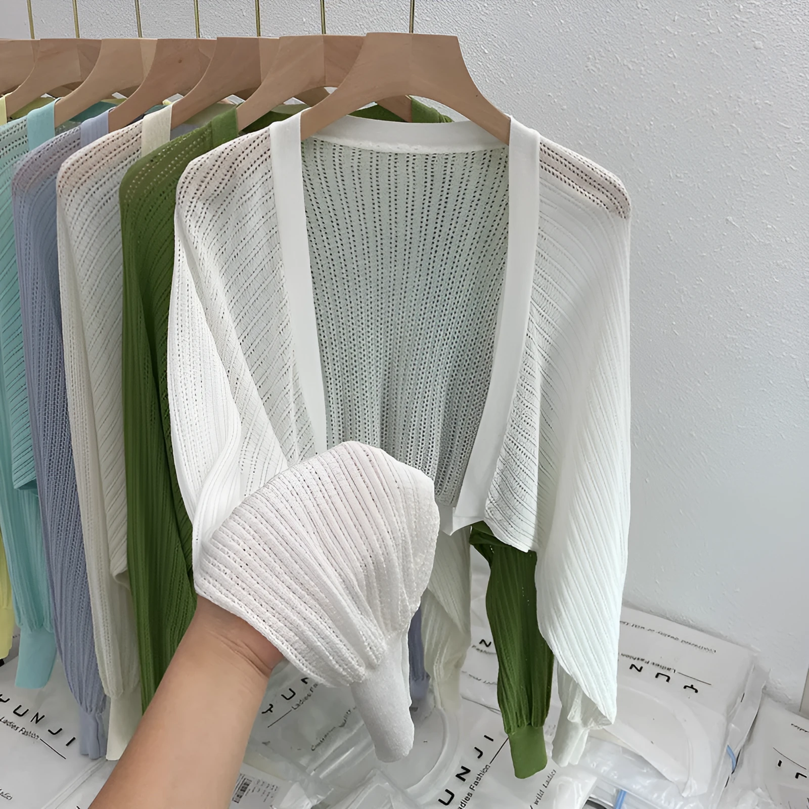 Thin polyester linen blouse with hollow out pattern and long lantern sleeves in apricot colour.