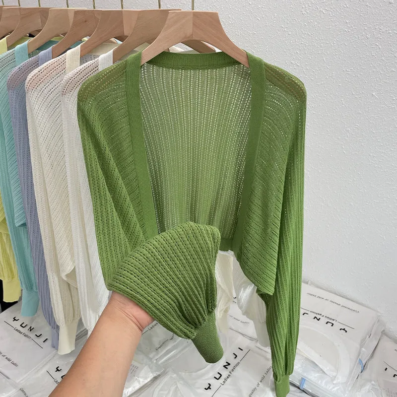 Thin polyester linen blouse with hollow out pattern and long lantern sleeves in apricot colour.