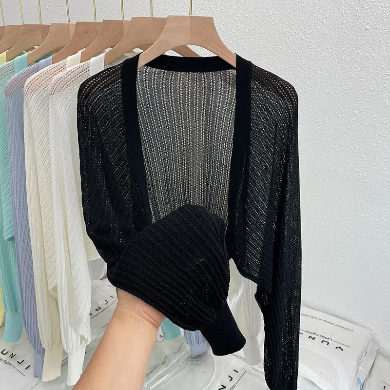 Thin polyester linen blouse with hollow out pattern and long lantern sleeves in apricot colour.