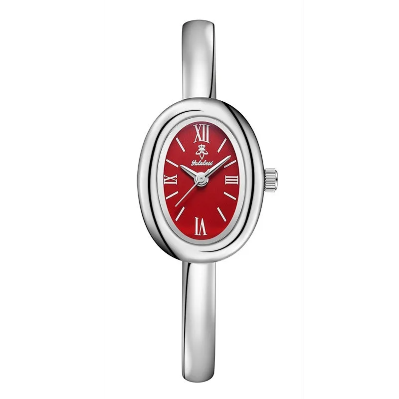 Women's gold and silver oval retro quartz watch with spiral patterns on a 8mm thick case.