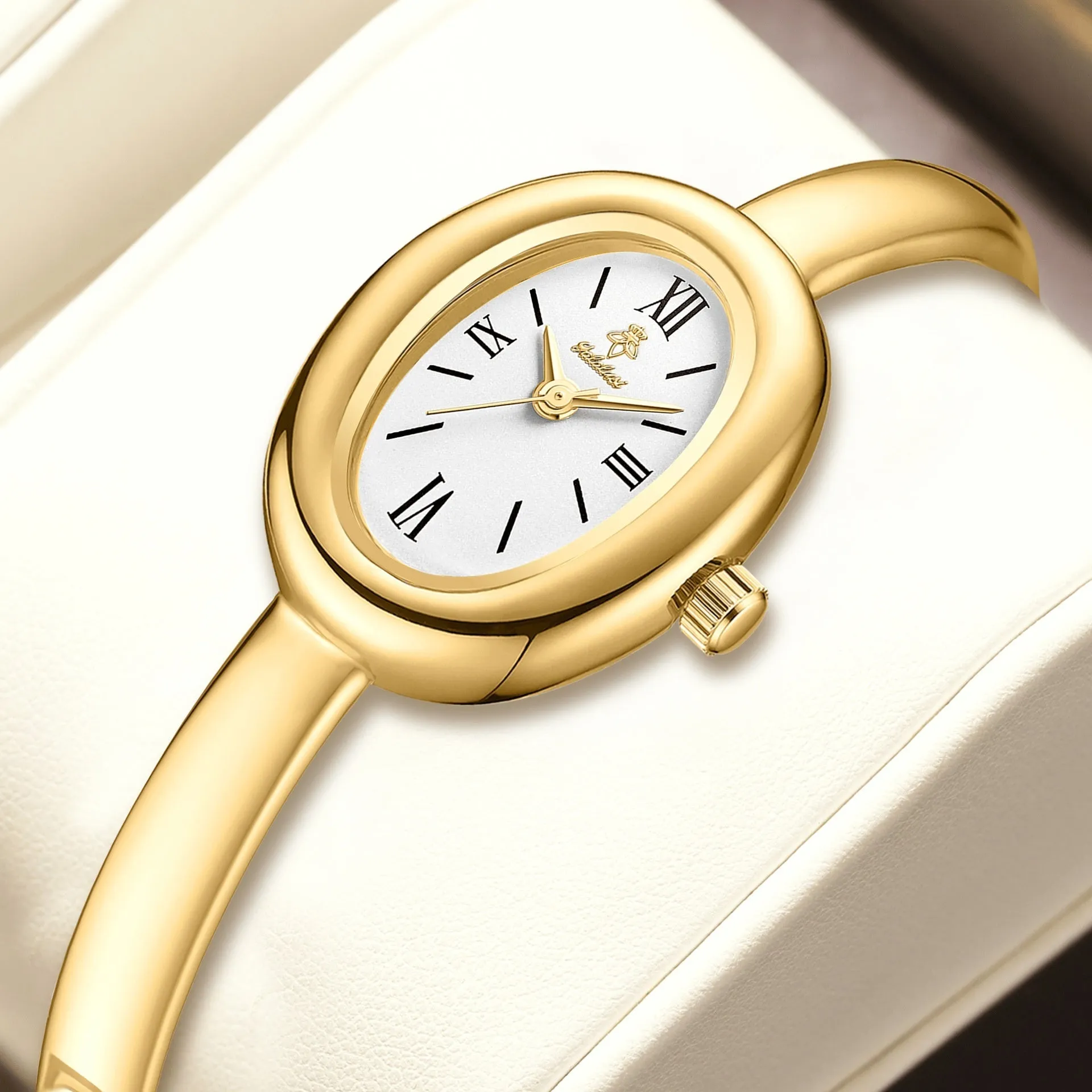 Women's gold and silver oval retro quartz watch with spiral patterns on a 8mm thick case.