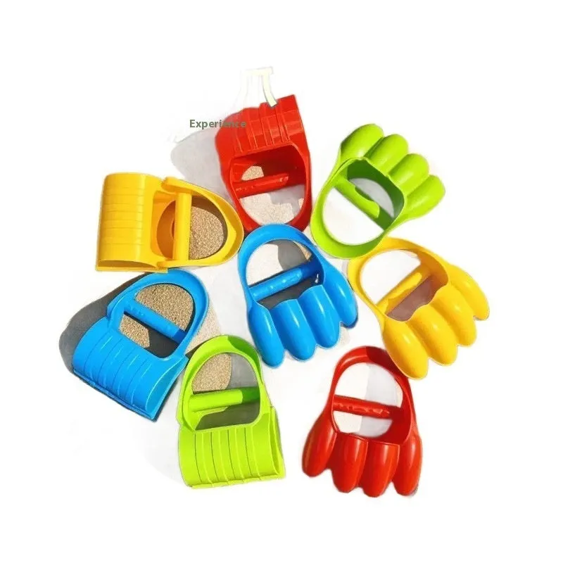 Two plastic sand digging shovels for children aged 4-6 years, set on a sandy surface near blue water.