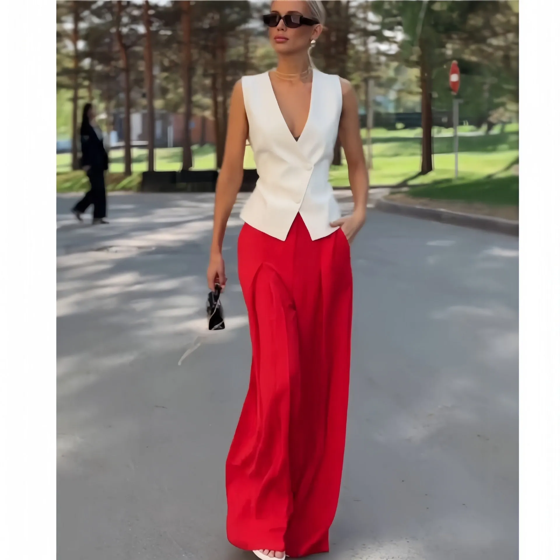 Women's beige two-piece set with deep V-neck sleeveless top and wide-leg trousers