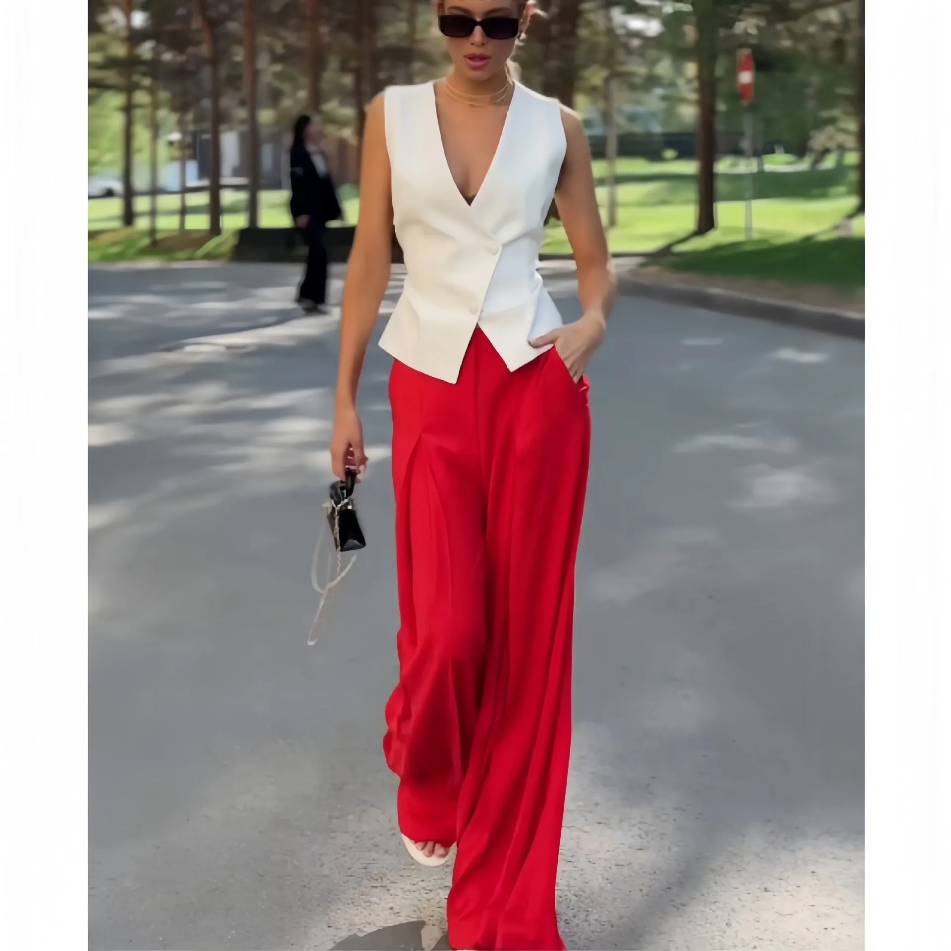 Women's beige two-piece set with deep V-neck sleeveless top and wide-leg trousers
