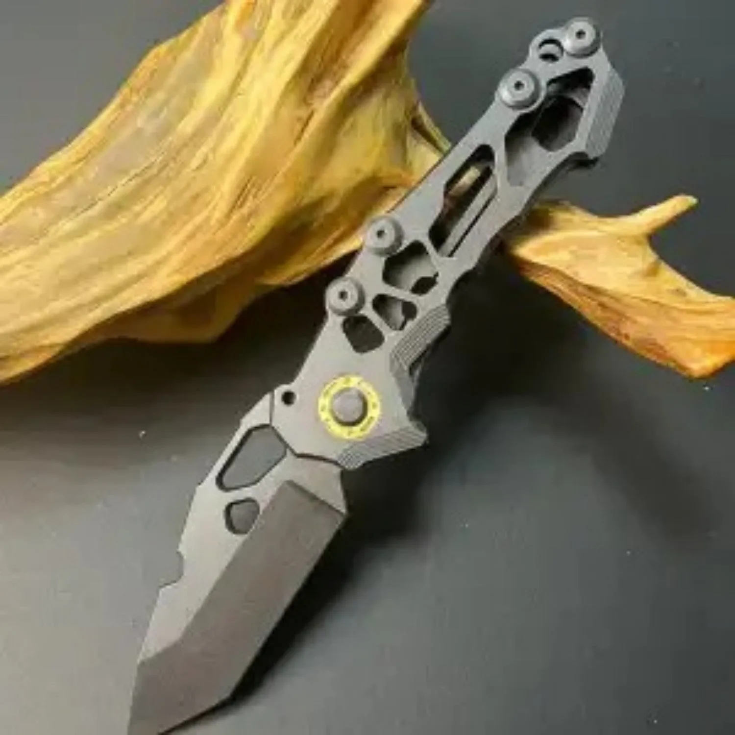 D2 steel folding knife with 9cm blade on outdoor background