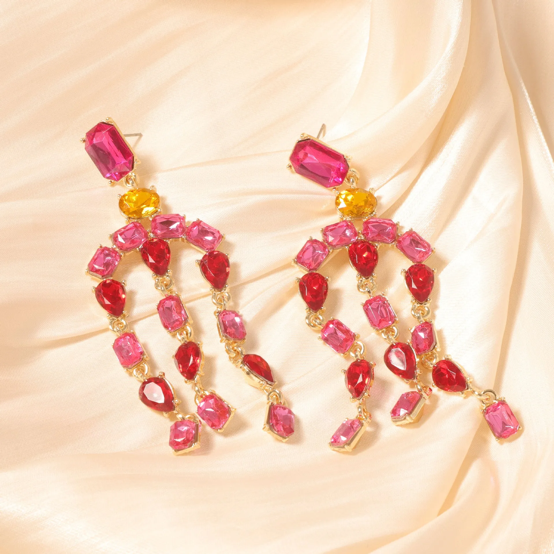 Heavy-duty full-drop diamond teardrop fringe earrings in zinc alloy, green colour, on display