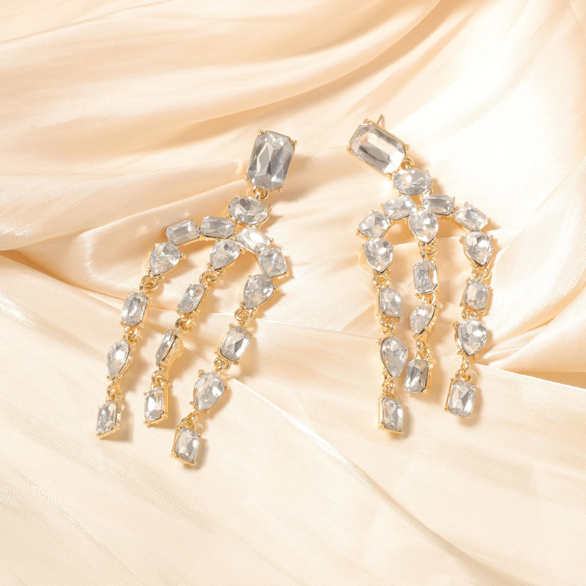 Heavy-duty full-drop diamond teardrop fringe earrings in zinc alloy, green colour, on display