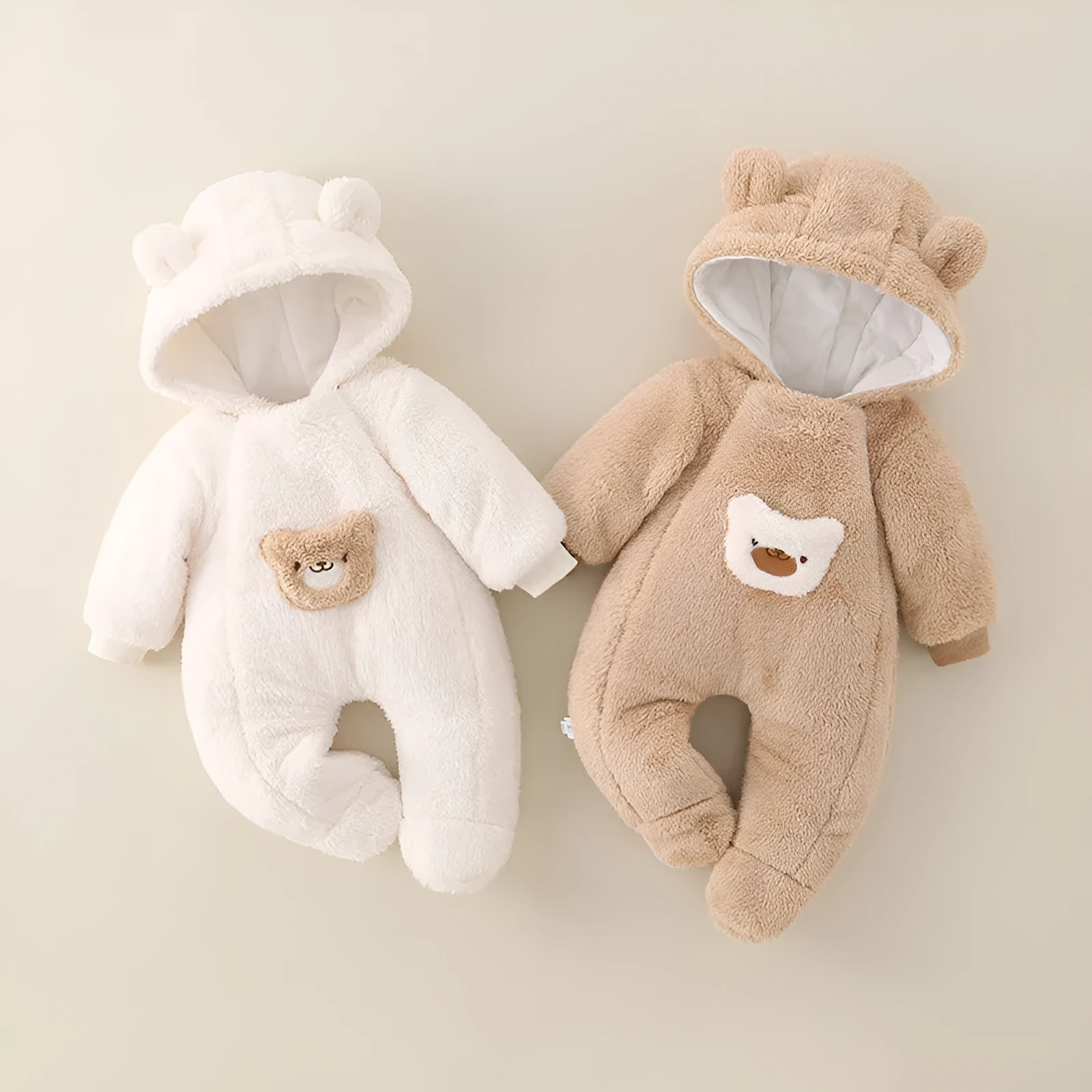 Unisex baby jumpsuit in milky white with full front zipper and long sleeves on white background