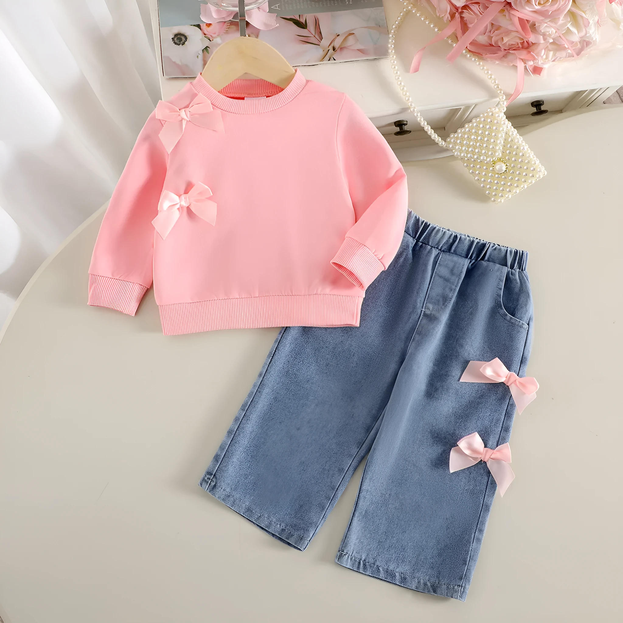 Pink two-piece baby girls outfit with long-sleeved sweater and trousers in cotton