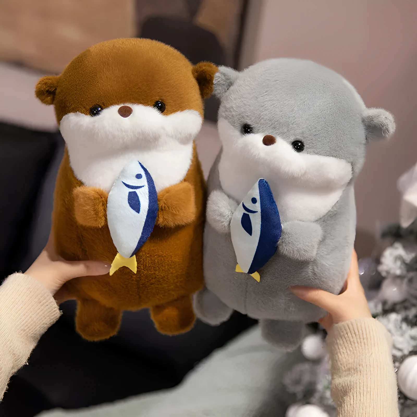 Small otter plush doll holding a fish in short plush fabric, available in brown and gray, 30cm or 40cm height
