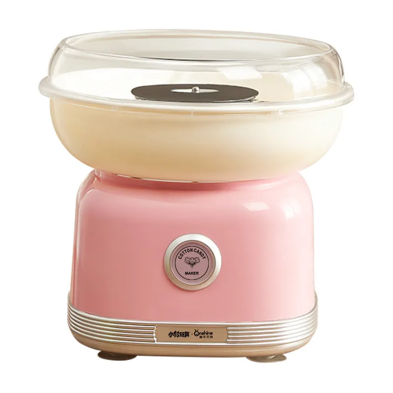 Pink mini electric cotton candy making machine with stainless steel body on a kitchen counter