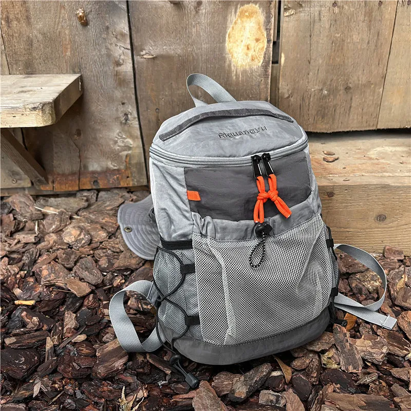 Waterproof nylon casual backpack in solid colour with curved shoulder straps and fold design details