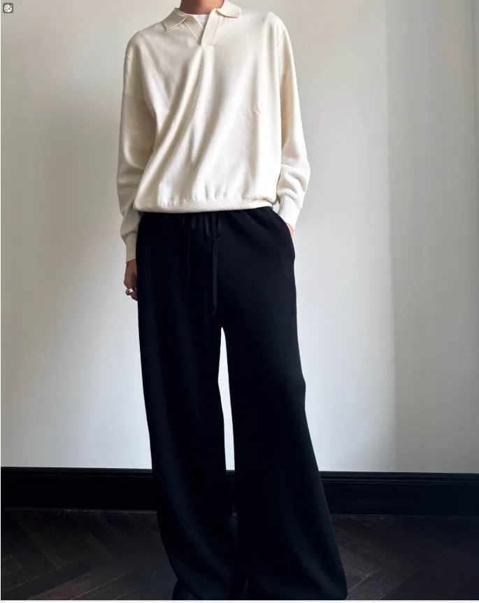 Pure wool polo sweater with a lapel collar in navy blue, shown in a loose fit on a model.