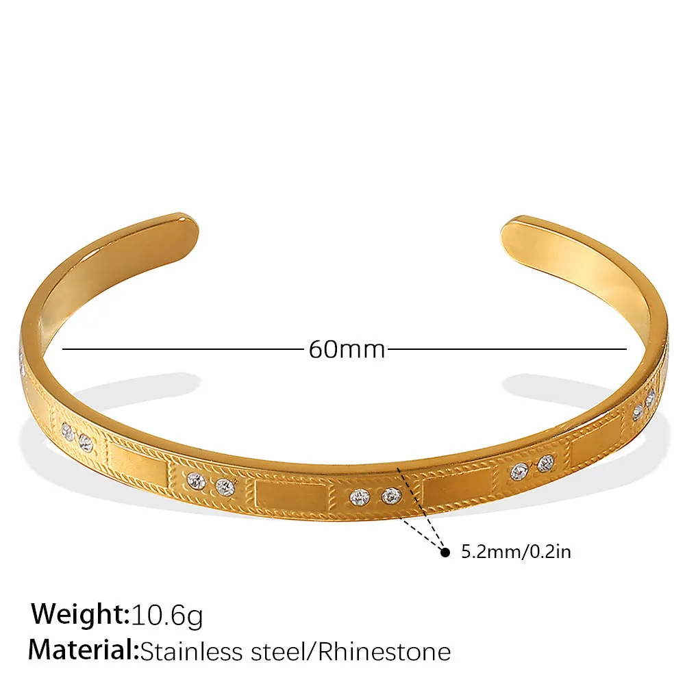 Stainless steel open-end bracelet with a buckle closure and circle design, shown in an electroplated gold colour.