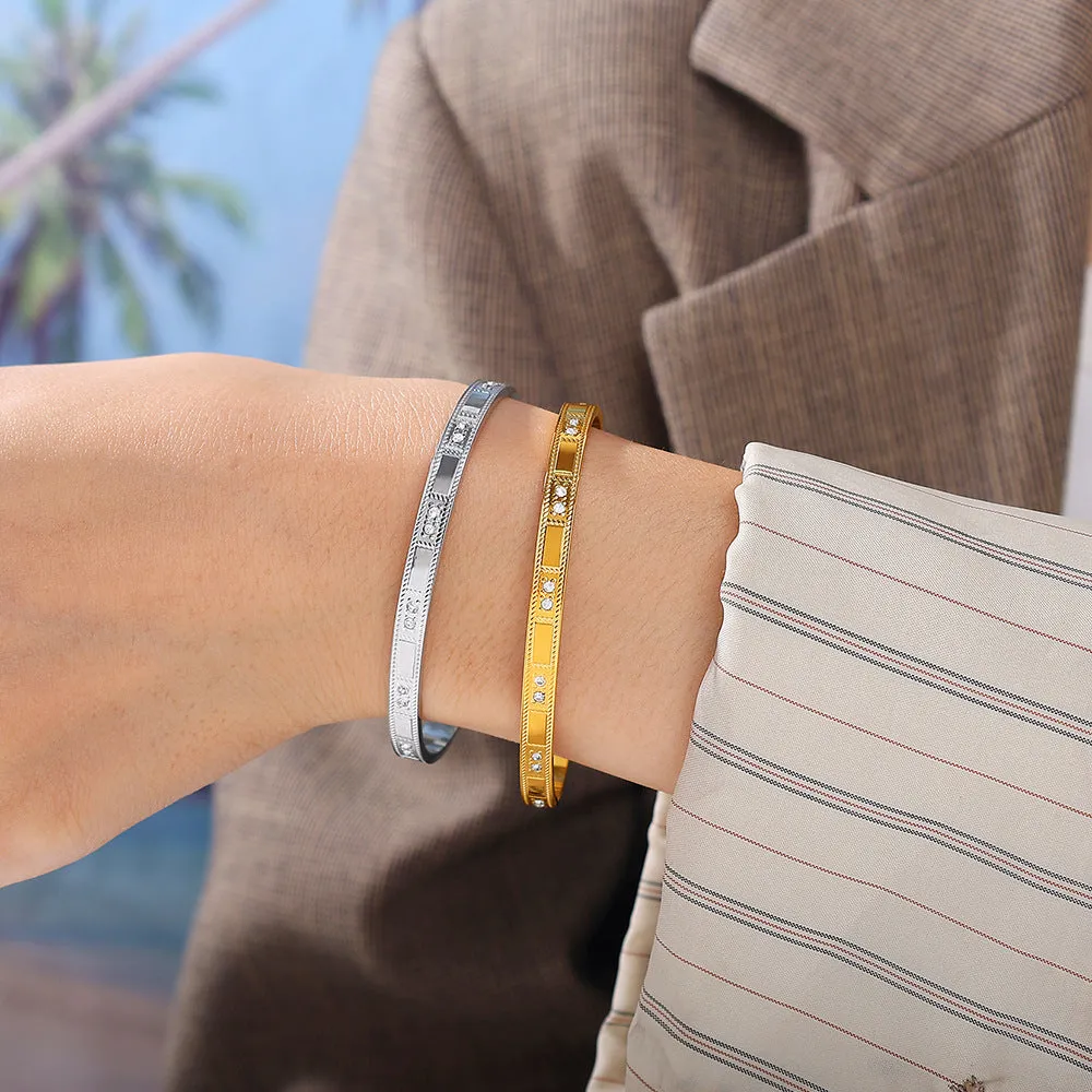Stainless steel open-end bracelet with a buckle closure and circle design, shown in an electroplated gold colour.