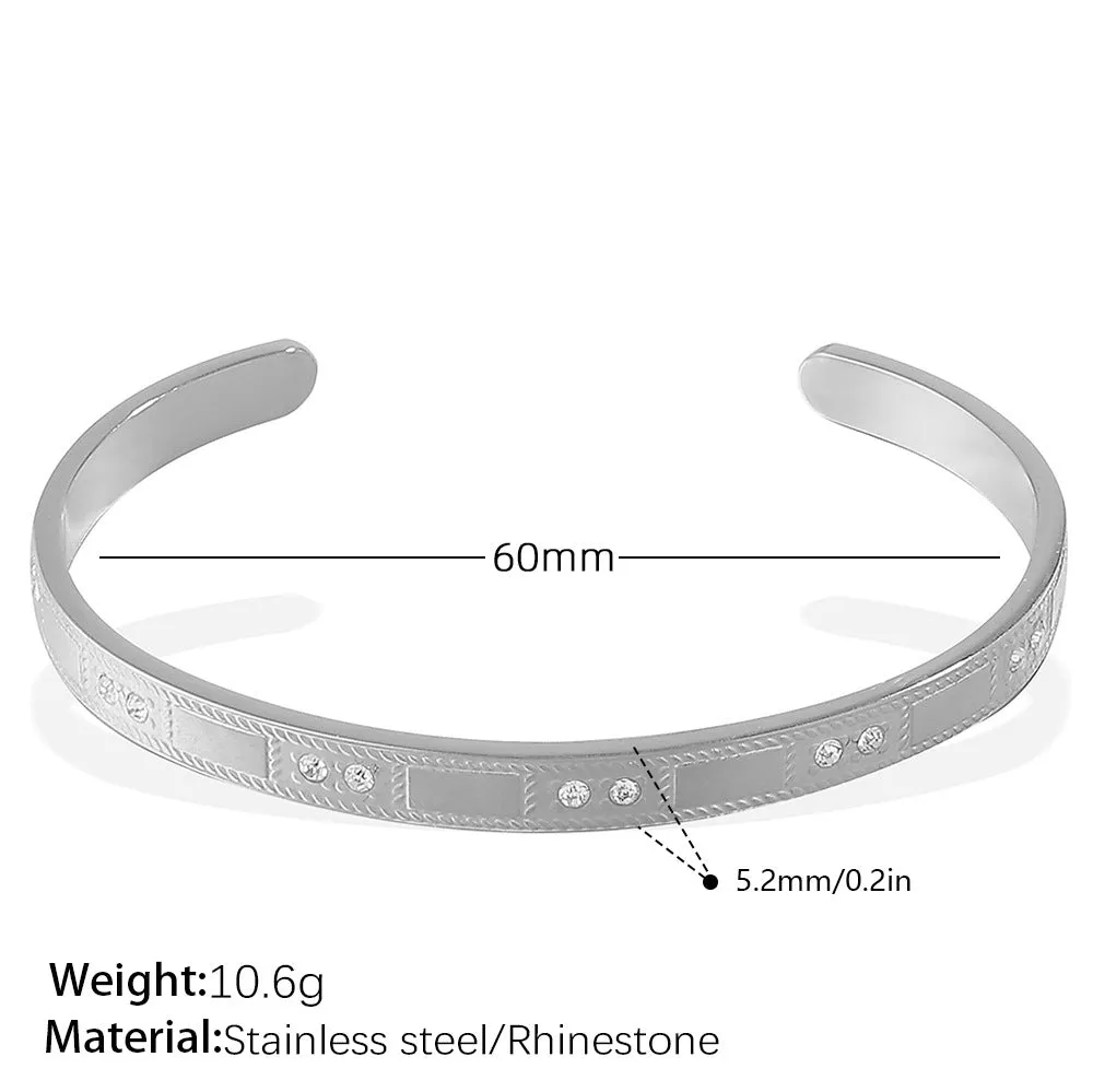 Stainless steel open-end bracelet with a buckle closure and circle design, shown in an electroplated gold colour.