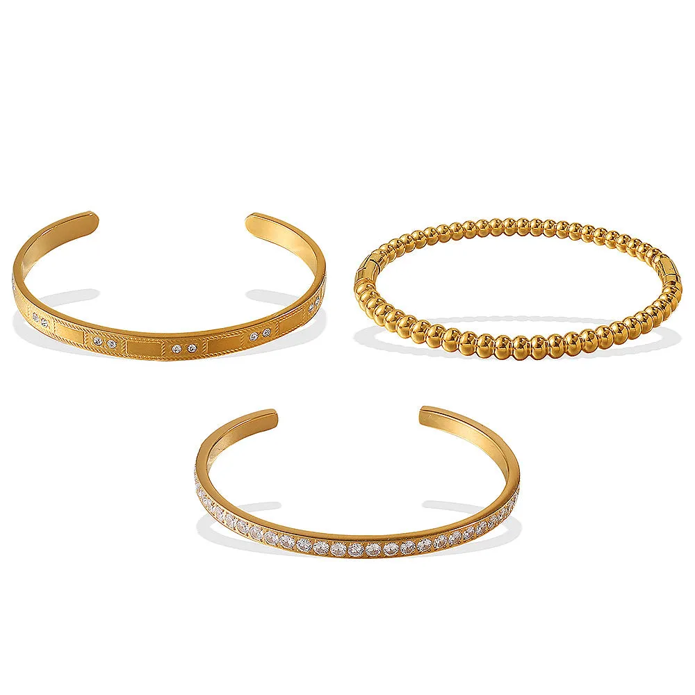 Stainless steel open-end bracelet with a buckle closure and circle design, shown in an electroplated gold colour.