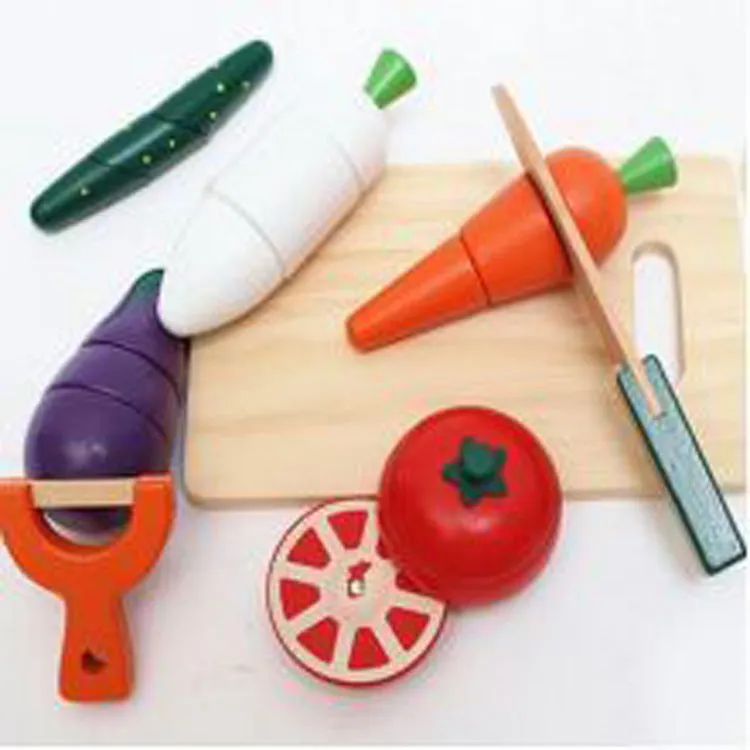 Children's wooden magnetic fruit and vegetable slicer toy on a table