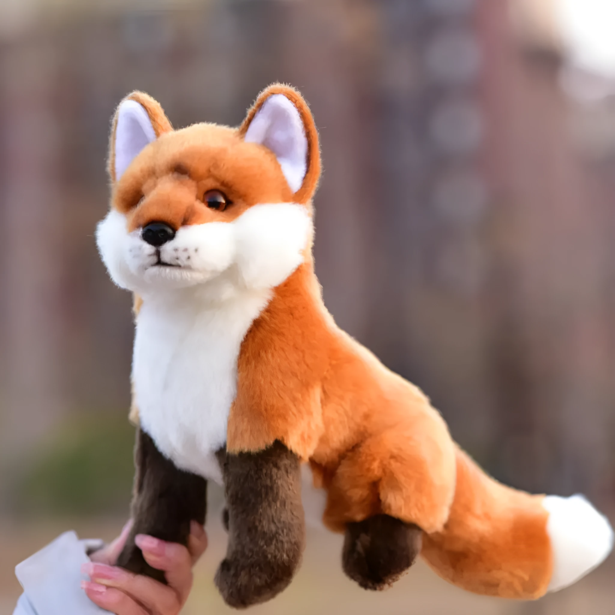 Soft plush toy animal doll approximately 25.5 cm tall in orange red colour, sitting firmly on a white desk surface