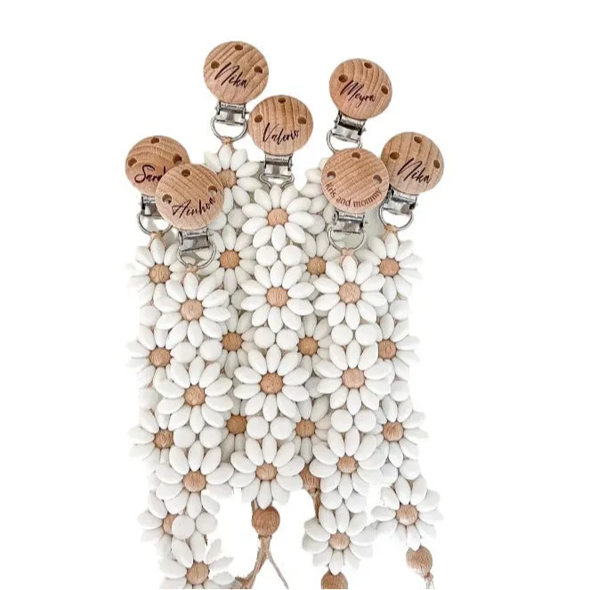 Baby flower silicone pacifier clip in pink on white background with custom name option
