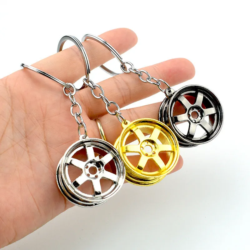 Stereo car wheel hub keychain in zinc alloy with gold, silver, and black colour options
