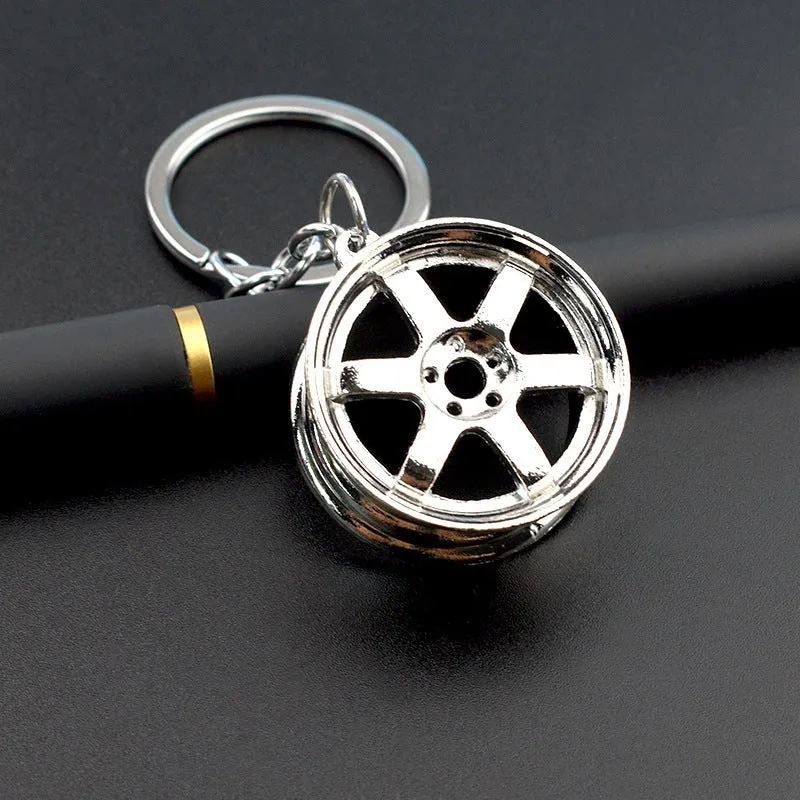 Stereo car wheel hub keychain in zinc alloy with gold, silver, and black colour options