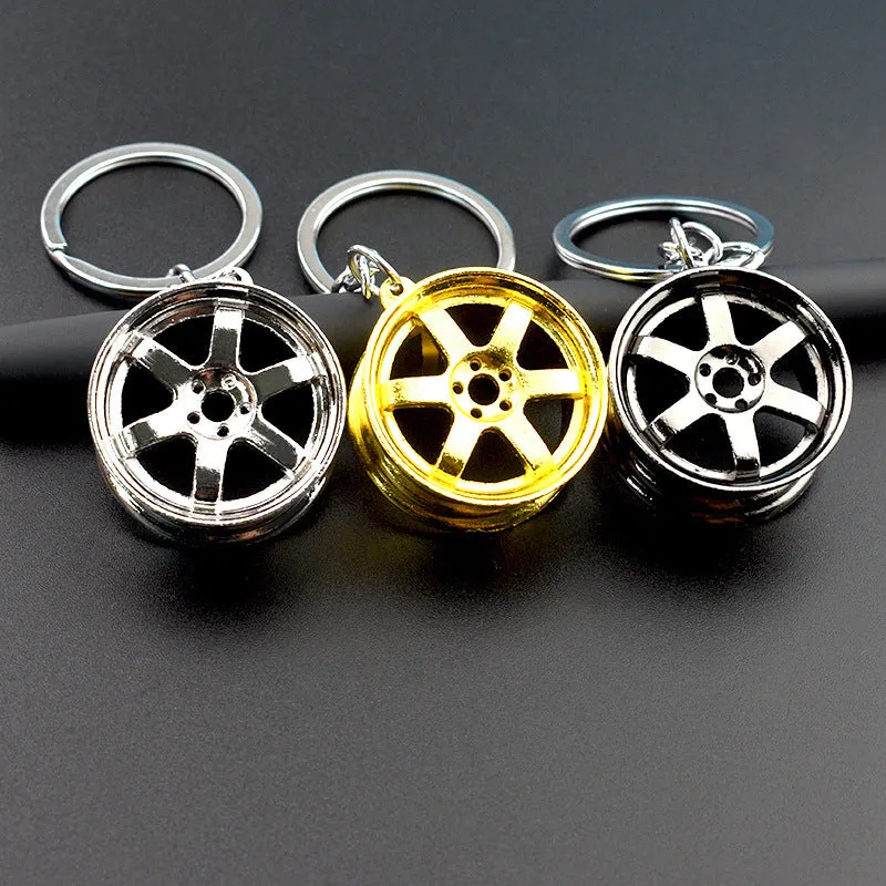 Stereo car wheel hub keychain in zinc alloy with gold, silver, and black colour options