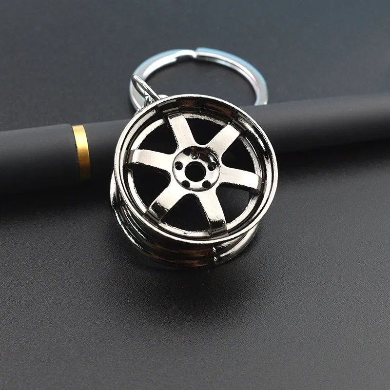 Stereo car wheel hub keychain in zinc alloy with gold, silver, and black colour options