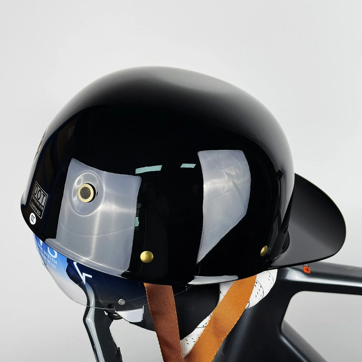 ABS motorcycle helmet in Black Feather design with blue lens visor, side view
