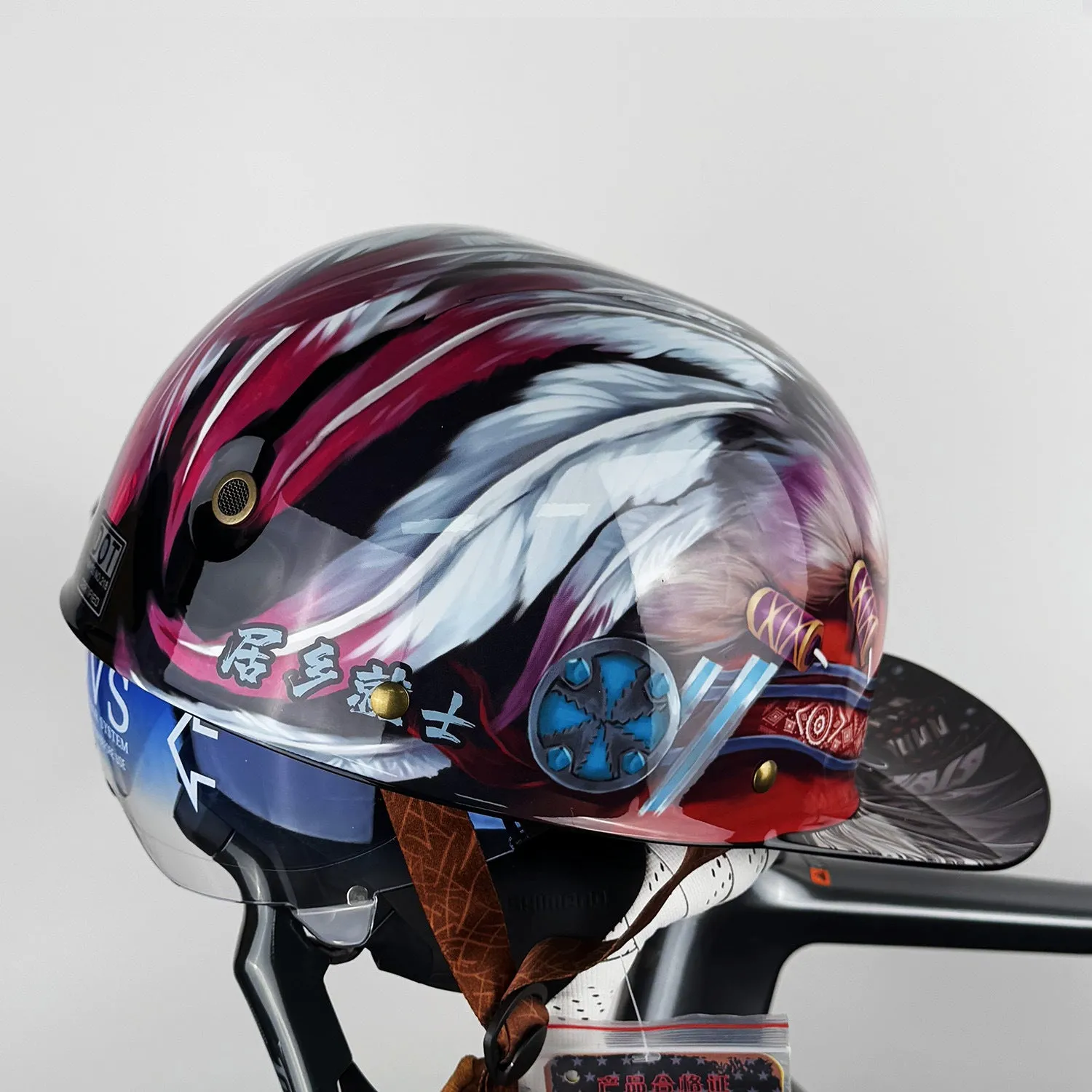 ABS motorcycle helmet in Black Feather design with blue lens visor, side view