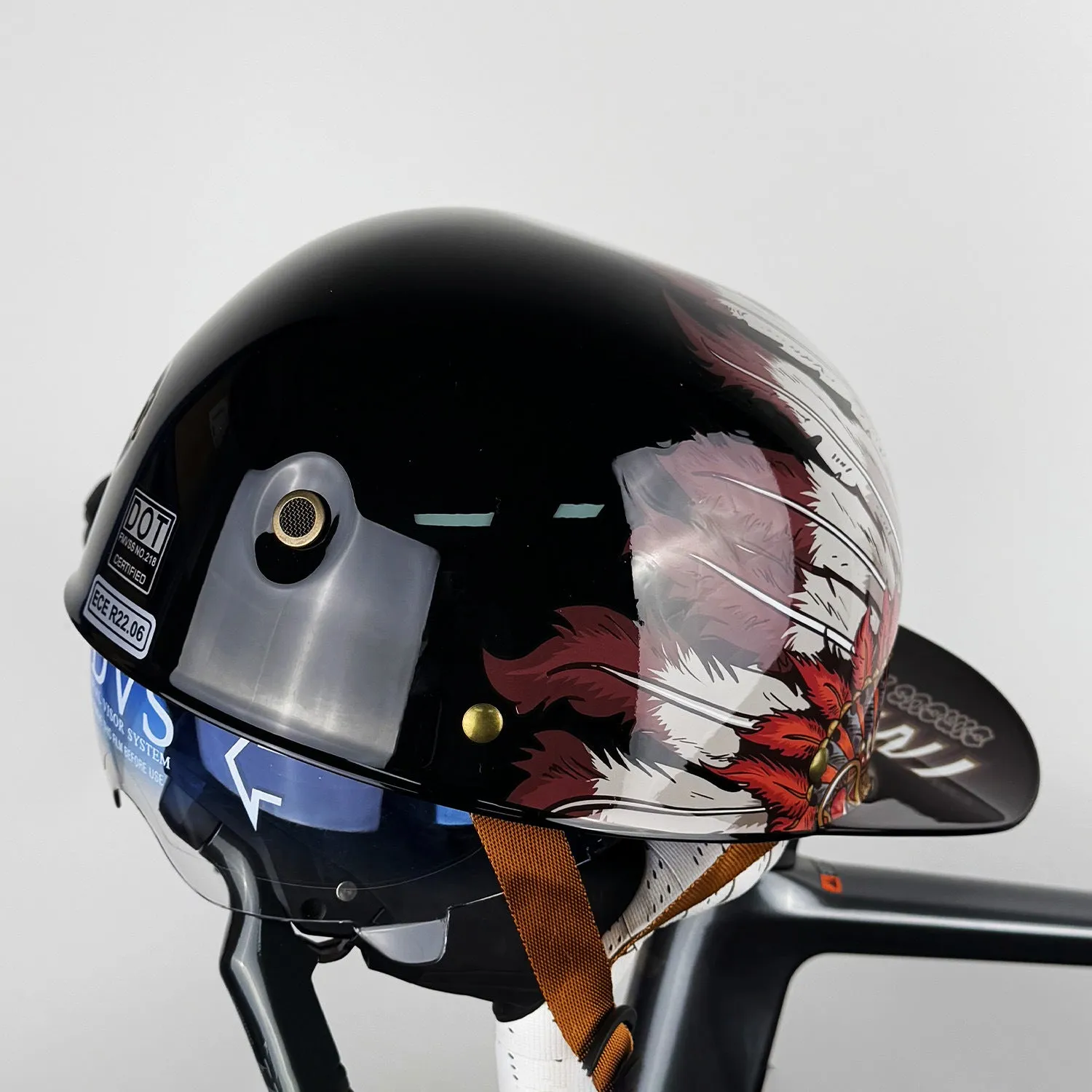 ABS motorcycle helmet in Black Feather design with blue lens visor, side view