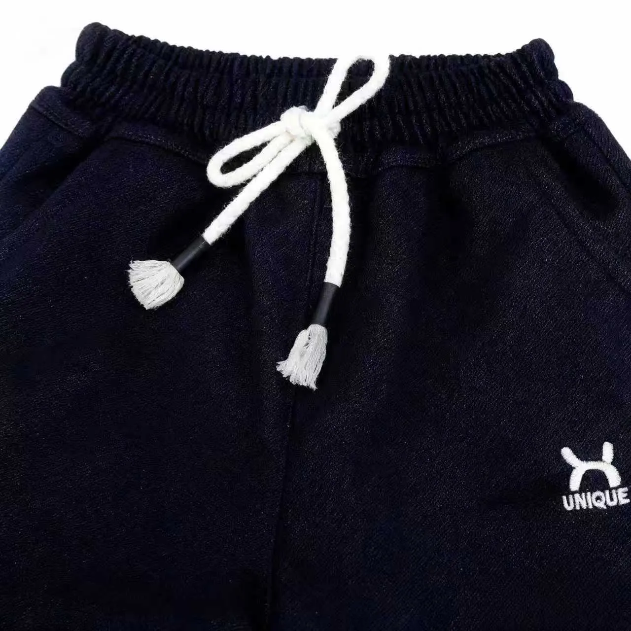 Children's trousers in black and blue with drawstring waist and ribbed hem, sizes 22-26 for ages 3-7