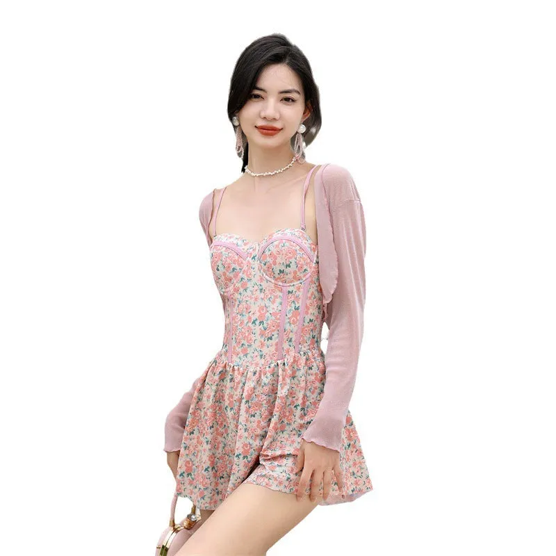 Women's pink floral jumpsuit swimsuit with adjustable suspender straps on mannequin