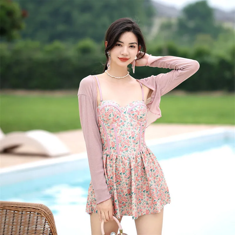 Women's pink floral jumpsuit swimsuit with adjustable suspender straps on mannequin