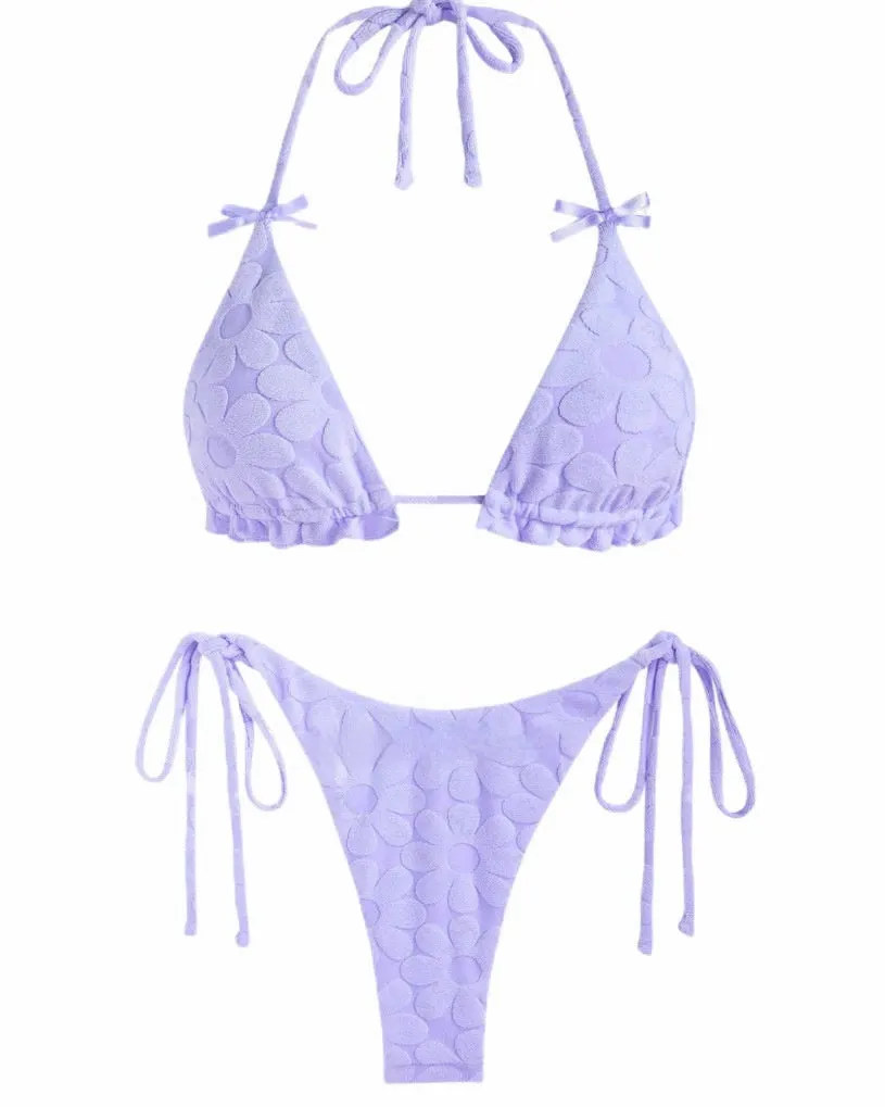 Women's light blue backless bikini swimsuit with strappy design on a mannequin.