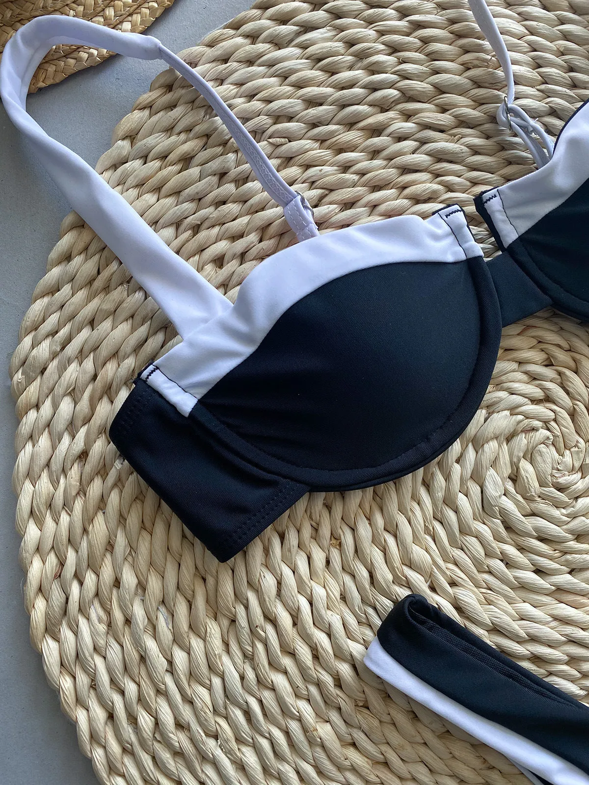 Black women's bikini briefs with stitching, showing front and back views