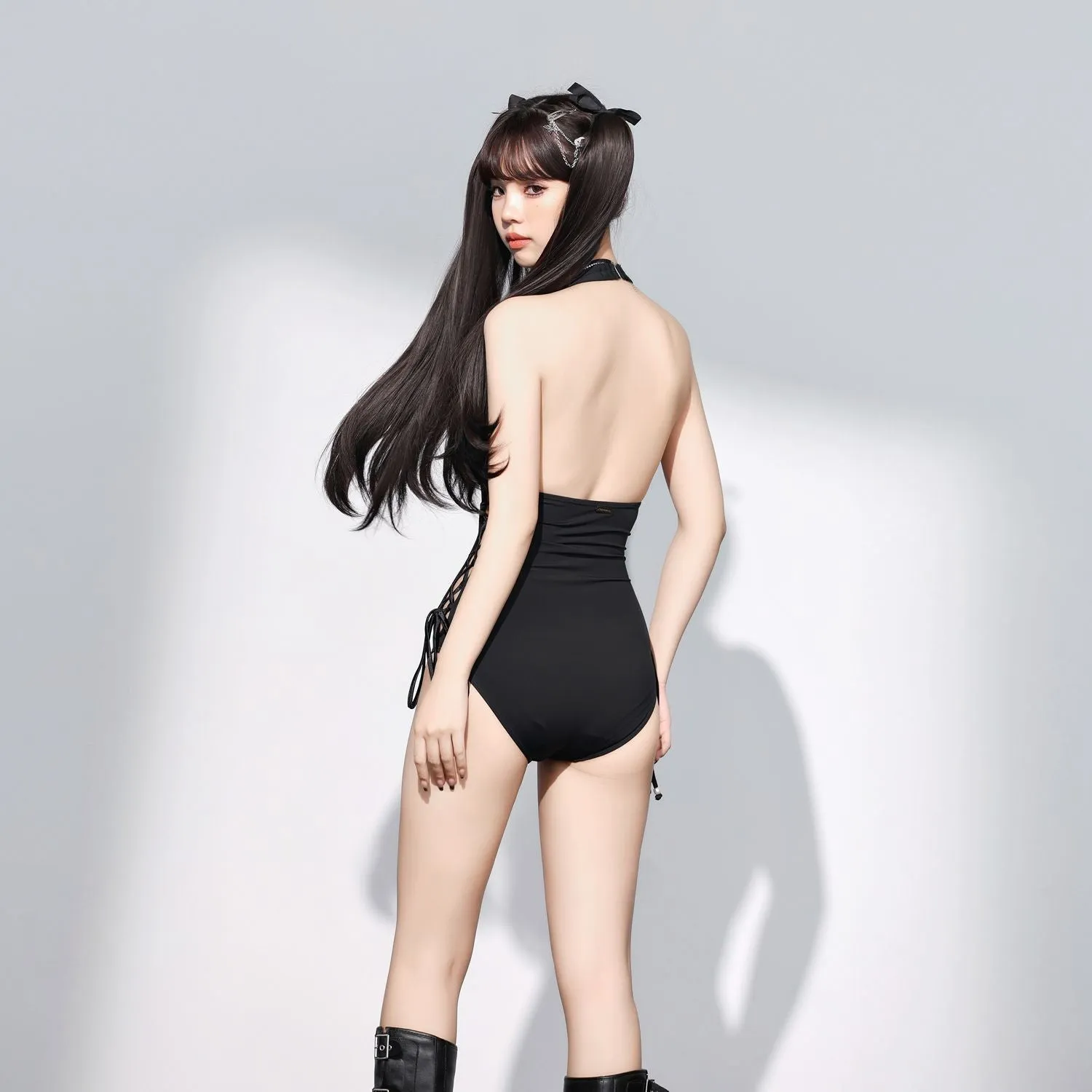 Black women's one-piece swimsuit with V-neck and hollow strap design.