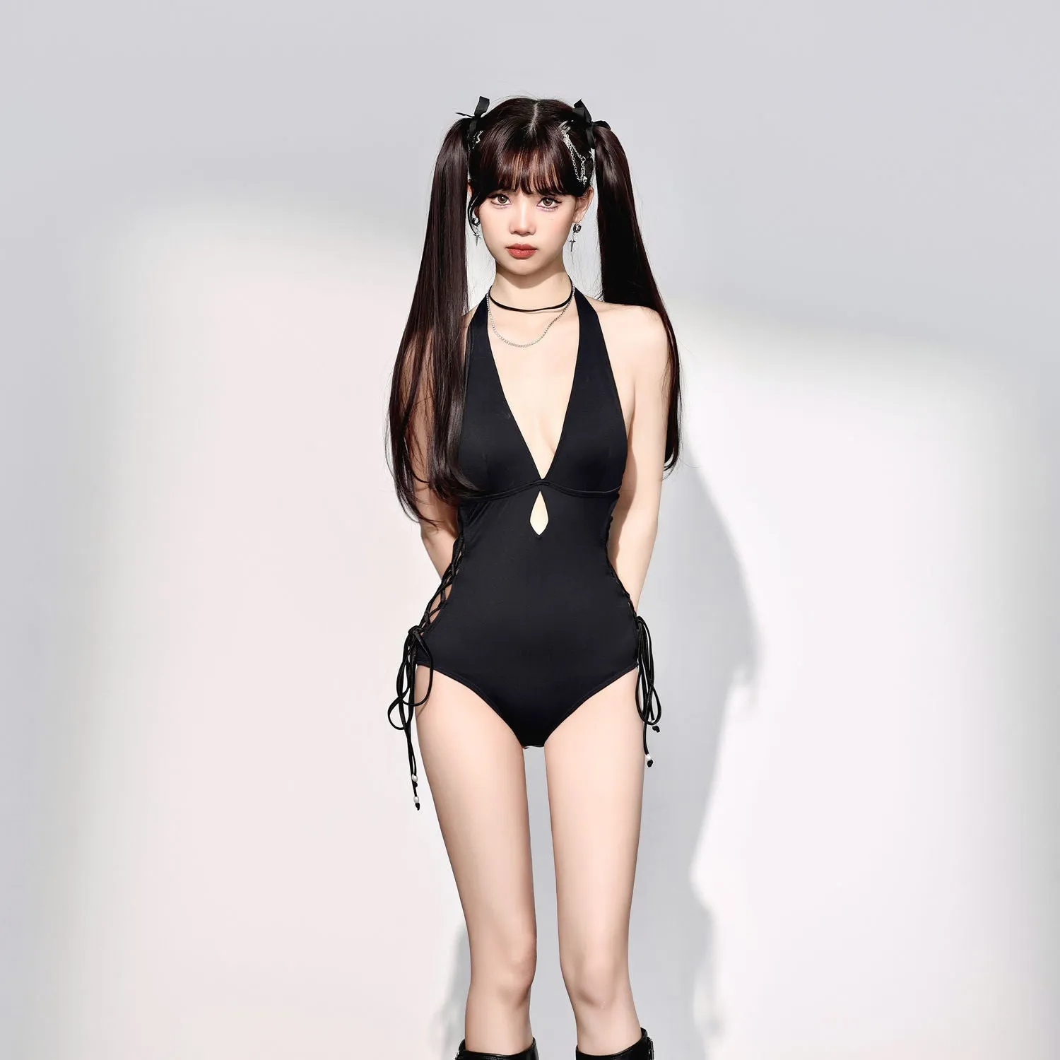 Black women's one-piece swimsuit with V-neck and hollow strap design.