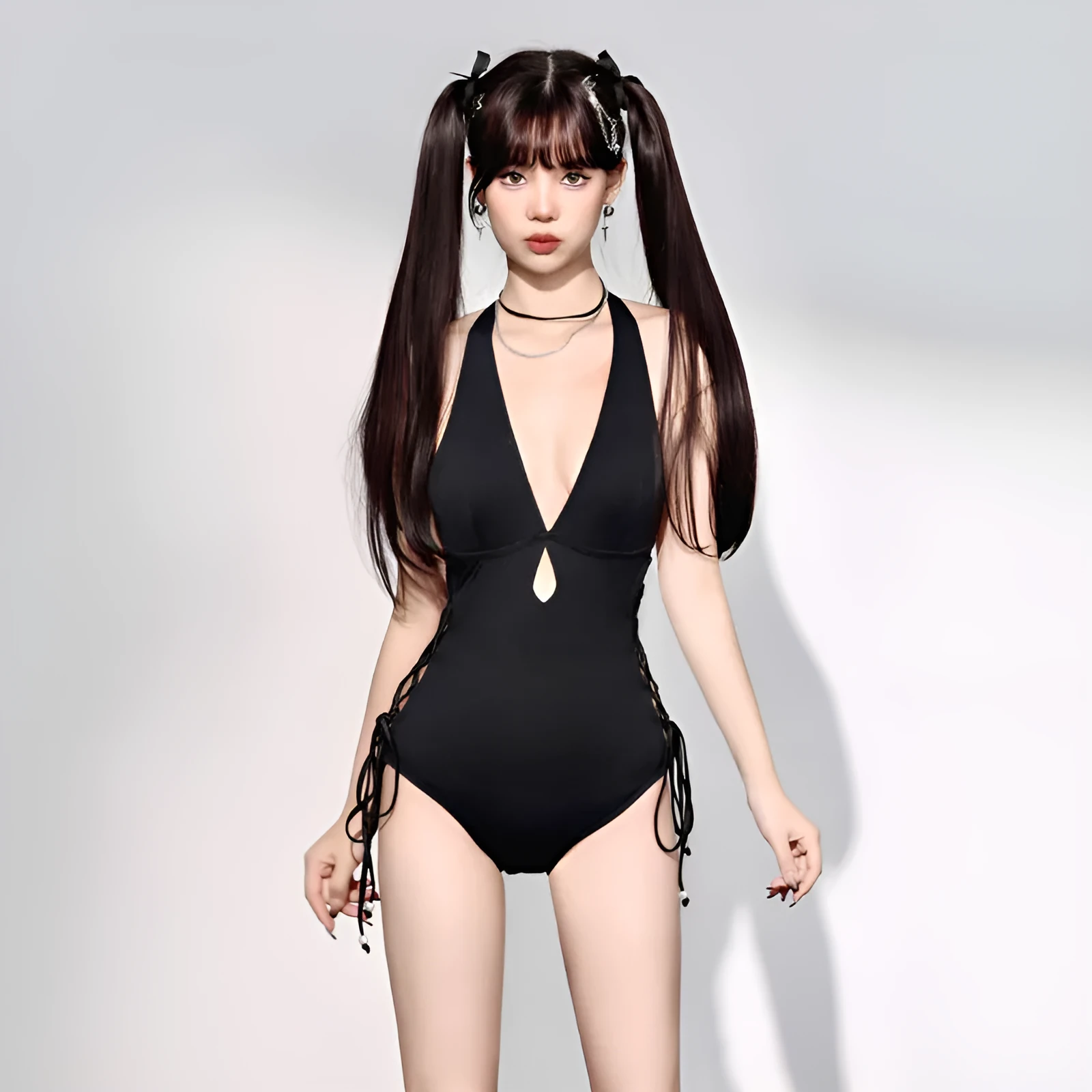 Black women's one-piece swimsuit with V-neck and hollow strap design.